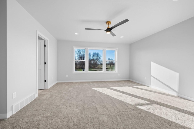 unfurnished room featuring ceiling fan and light colored carpet