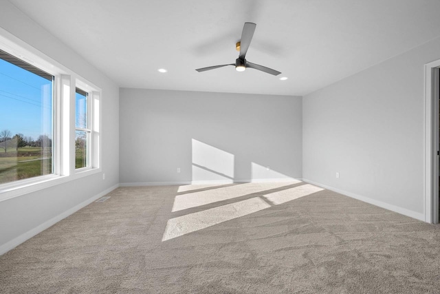 empty room featuring ceiling fan and light carpet