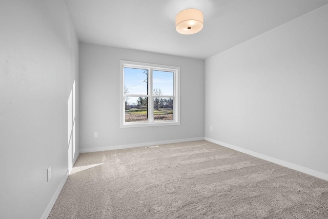 unfurnished room featuring light colored carpet