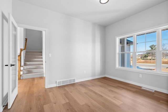 spare room featuring light wood-type flooring