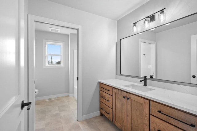 bathroom featuring vanity and toilet