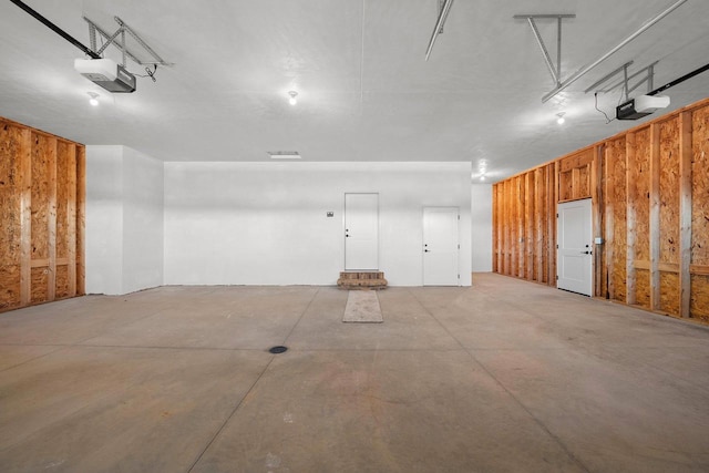 garage featuring wooden walls and a garage door opener