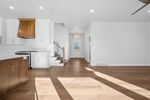 foyer entrance with light hardwood / wood-style floors and a notable chandelier