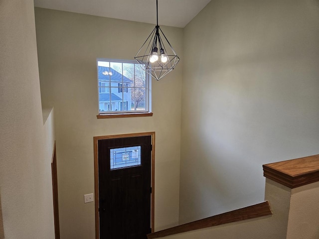 foyer featuring a chandelier