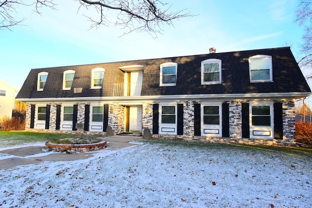 view of front of house featuring a balcony