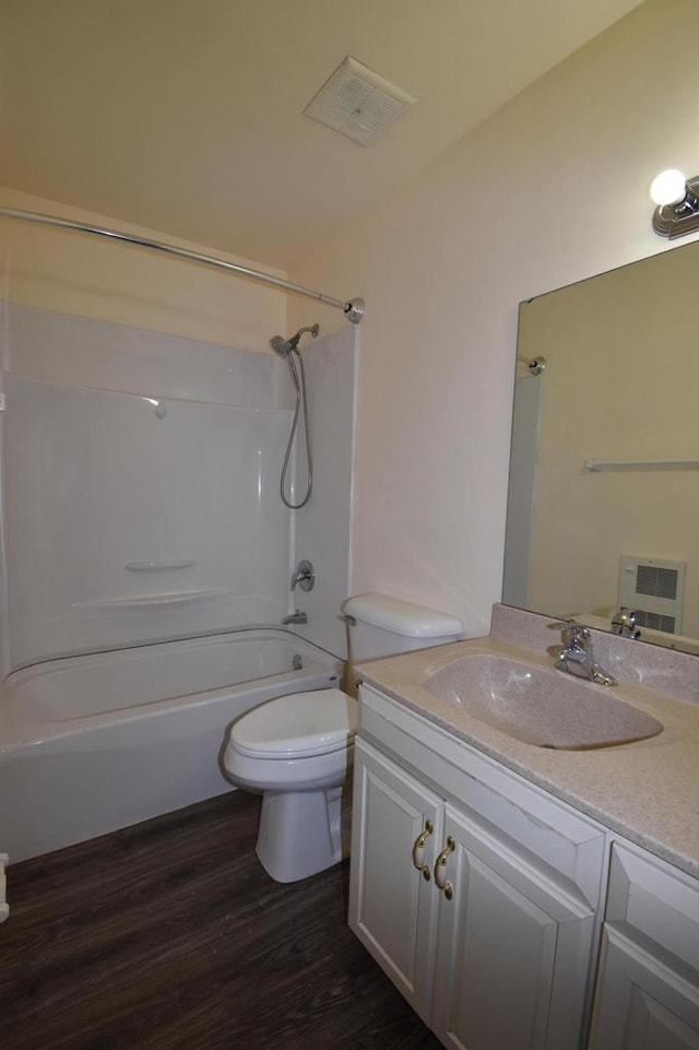 full bathroom featuring shower / bathing tub combination, vanity, hardwood / wood-style flooring, and toilet