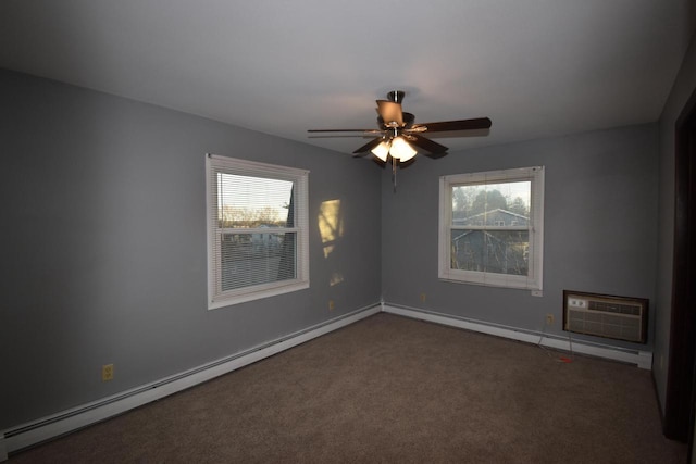 spare room featuring dark carpet, a wall mounted AC, a baseboard heating unit, and ceiling fan