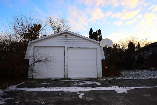 view of garage at dusk