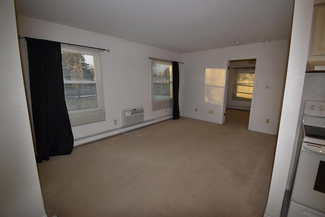 empty room featuring light colored carpet and a baseboard radiator