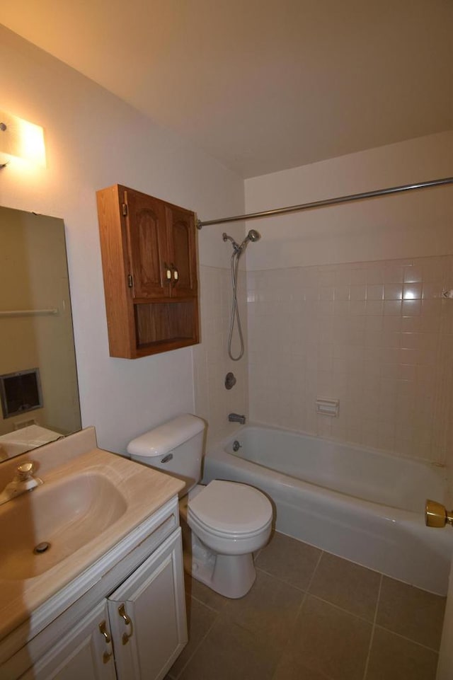 full bathroom featuring toilet, vanity, tile patterned floors, and tiled shower / bath combo