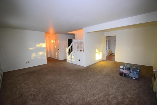 spare room featuring dark colored carpet