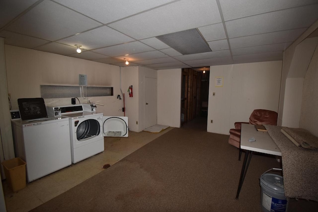 washroom with washing machine and clothes dryer and light carpet