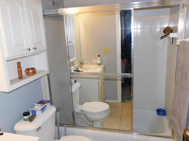 full bathroom with toilet, vanity, tile patterned floors, and enclosed tub / shower combo