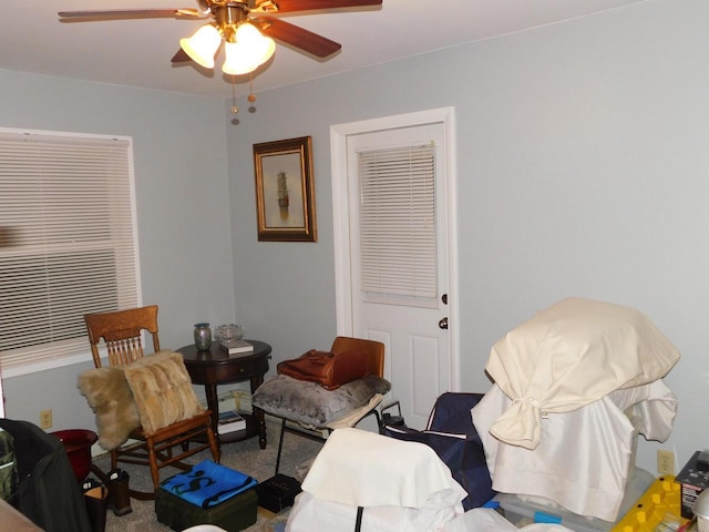 living area with ceiling fan