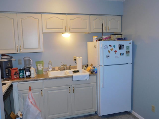 kitchen featuring white cabinetry, white appliances, and sink