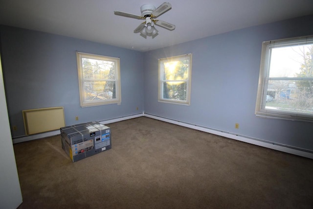 carpeted spare room featuring a baseboard radiator and ceiling fan