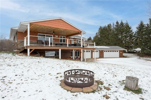 view of front facade featuring a garage, ceiling fan, and a deck