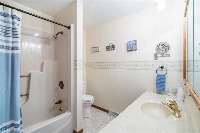 full bathroom with tile patterned floors, vanity, toilet, and shower / tub combo