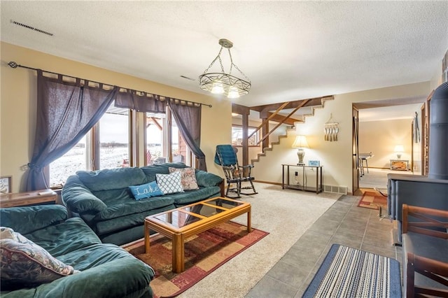 carpeted living room with a textured ceiling and a wood stove