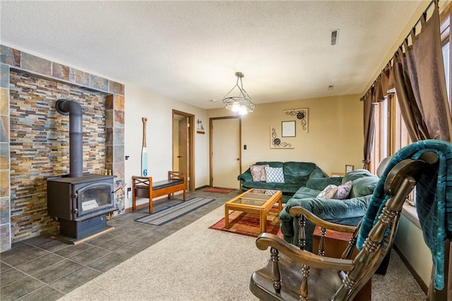 carpeted living room featuring a textured ceiling and a wood stove