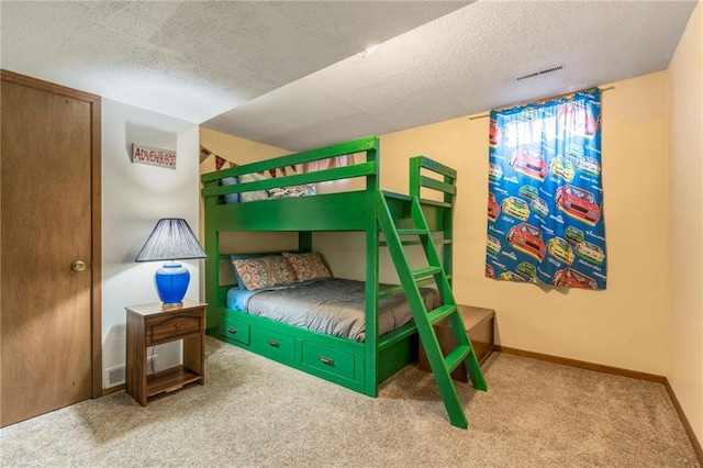 carpeted bedroom with a textured ceiling