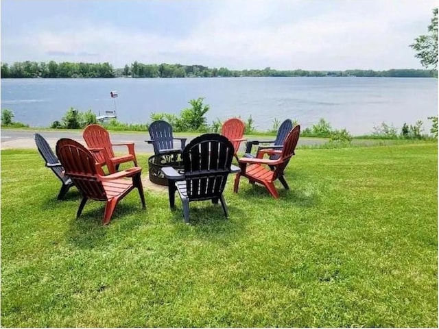 view of yard with a water view and an outdoor fire pit