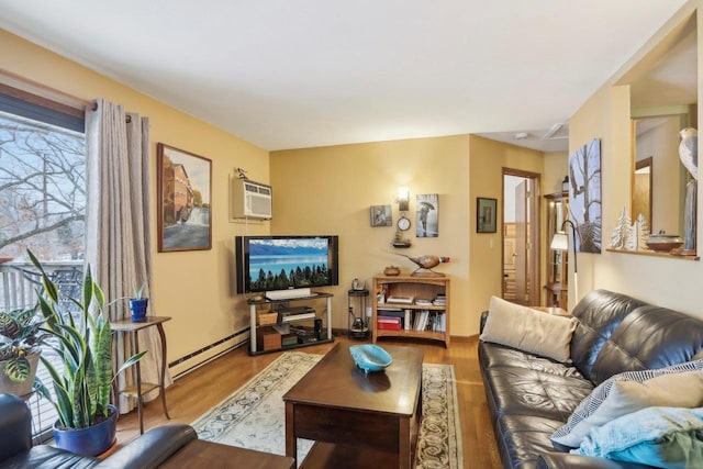 living room featuring hardwood / wood-style flooring, an AC wall unit, and a baseboard heating unit