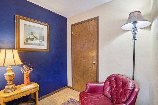 sitting room with hardwood / wood-style flooring