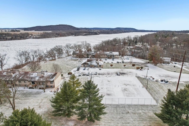 snowy aerial view with a mountain view