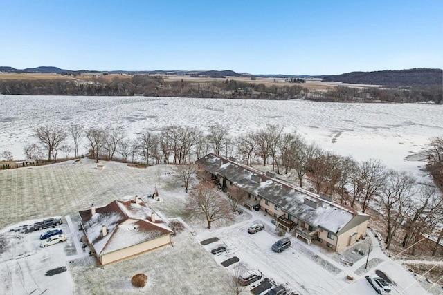 snowy aerial view with a mountain view