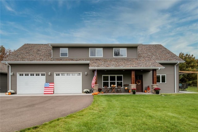 view of front of property with a garage, covered porch, and a front yard