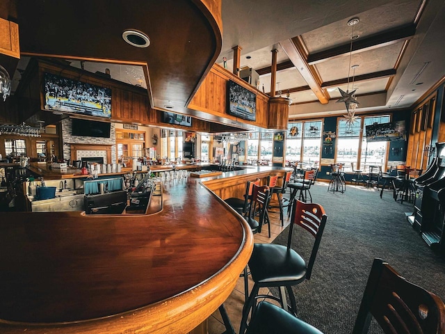 bar featuring carpet flooring, beamed ceiling, and coffered ceiling