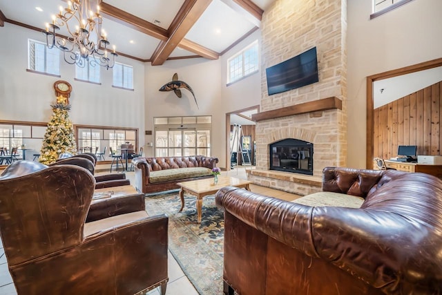 tiled living room with a notable chandelier, wood walls, a stone fireplace, and a high ceiling