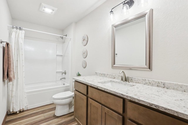 bathroom with visible vents, toilet, wood finished floors, shower / bathtub combination with curtain, and vanity