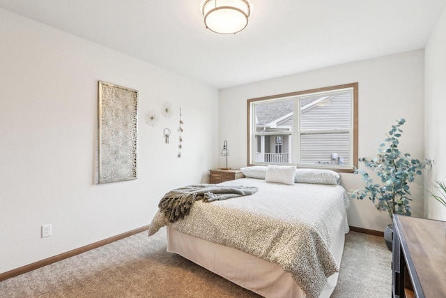 bedroom featuring baseboards and light colored carpet