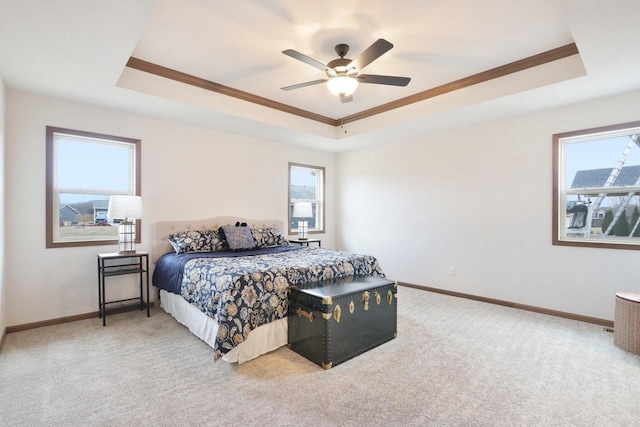 bedroom featuring carpet floors, a tray ceiling, and baseboards