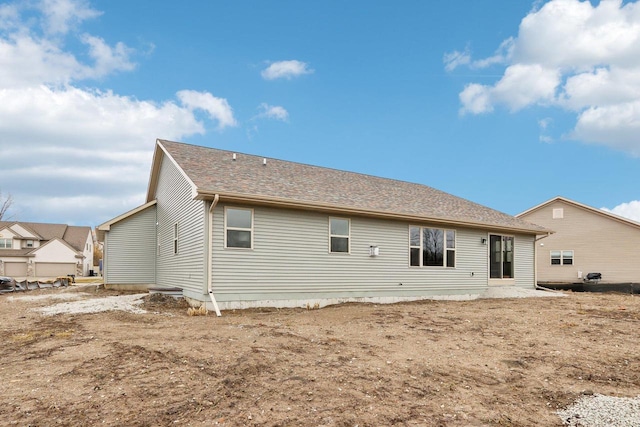 back of property featuring a shingled roof