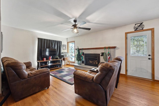 living room featuring ceiling fan and light hardwood / wood-style floors