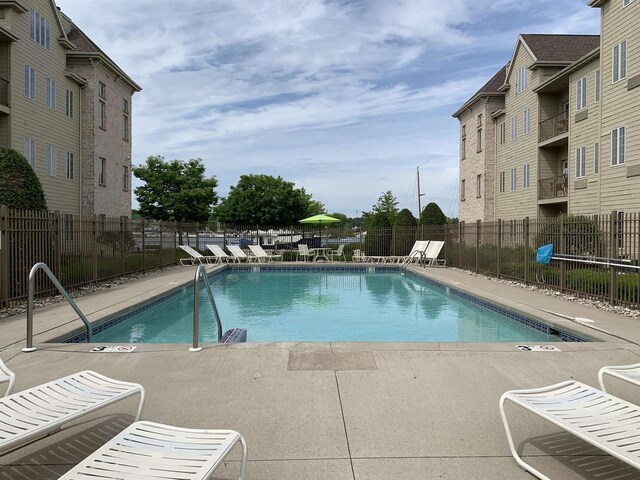 view of swimming pool with a patio area