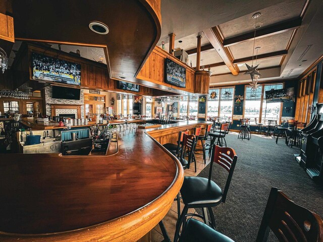 bar with beam ceiling, carpet floors, and coffered ceiling