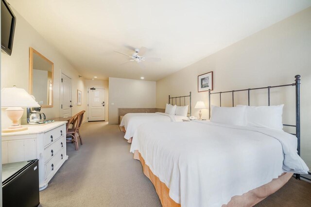 bedroom featuring light carpet and ceiling fan