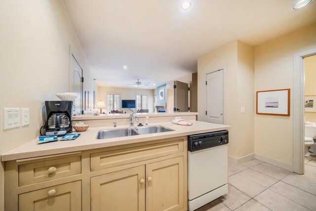 kitchen featuring ceiling fan, sink, white dishwasher, cream cabinetry, and light tile patterned floors