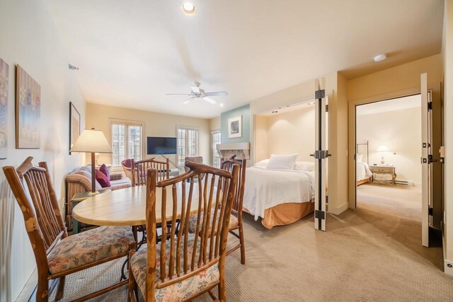 carpeted dining room featuring ceiling fan