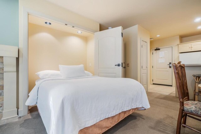 bedroom featuring light carpet