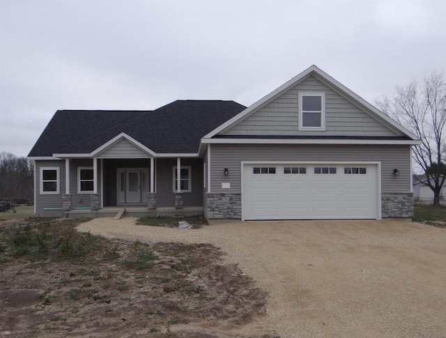 craftsman inspired home with a porch and a garage