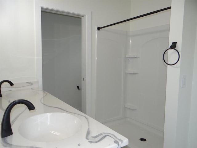 bathroom with walk in shower and sink