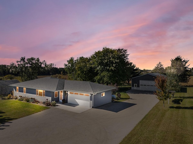 view of front of house with a garage and a lawn