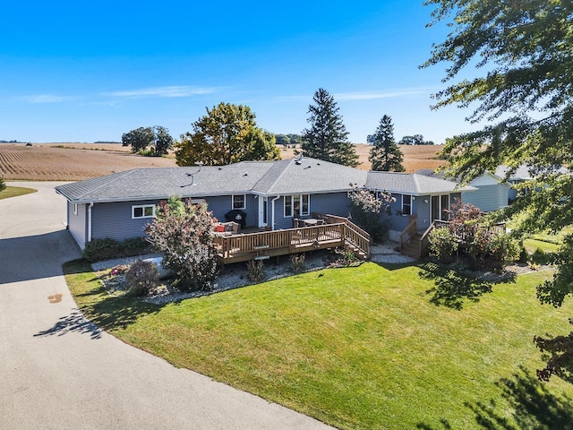 view of front of house featuring a front yard and a deck