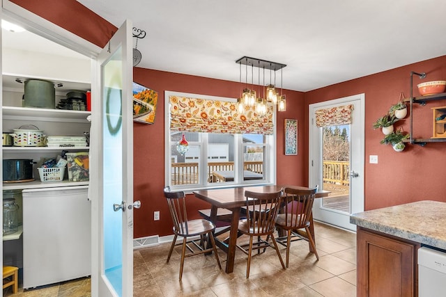 dining area with an inviting chandelier