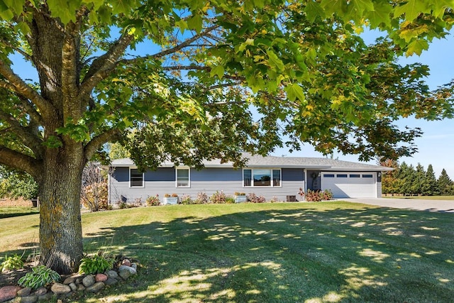 ranch-style home featuring a garage and a front yard